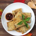 Egg Martabak with soy souce in the white plate on wooden table