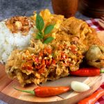 Rice with Spicy Fried Chicken, Fried Egg, and Meatball in wooden tray